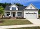 Charming new construction home with a two-car garage, landscaped front yard, and inviting front porch at 6040 Scalybark Road, Durham, NC 27712