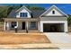 Beautiful new construction home with white siding, brick accents and an attached two car garage at 6040 Scalybark Road, Durham, NC 27712