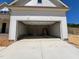 Spacious two car garage ready for your vehicles with a concrete driveway leading to the street at 6040 Scalybark Road, Durham, NC 27712