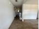 Bright hallway featuring beautiful hardwood floors, wainscoting, and access to staircase at 6040 Scalybark Road, Durham, NC 27712