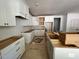Spacious kitchen featuring white cabinets, plenty of counter space, and an open design concept at 6040 Scalybark Road, Durham, NC 27712