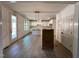 Open floor plan with view to the kitchen with white cabinets, island and stainless appliances at 6040 Scalybark Road, Durham, NC 27712