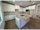 Stylish kitchen with white cabinets, granite countertops, stainless steel appliances, and center island at 6040 Scalybark Road, Durham, NC 27712