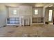 Living room with custom built-in shelving surrounding a fireplace and large windows for natural light at 6040 Scalybark Road, Durham, NC 27712