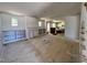 Open concept living room with built-in shelving surrounding a fireplace and many windows for natural light at 6040 Scalybark Road, Durham, NC 27712