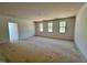 A spacious living room featuring three windows and an open floor plan at 6040 Scalybark Road, Durham, NC 27712