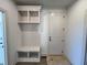 Mudroom featuring built-in shelving and a bench with storage beneath, next to front door at 6040 Scalybark Road, Durham, NC 27712