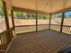A covered wooden porch overlooks a natural landscape in this attractive home at 6040 Scalybark Road, Durham, NC 27712