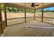 Large screened-in porch with wood flooring and a view of the wooded backyard at 6040 Scalybark Road, Durham, NC 27712