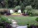 Relaxing seating area with white adirondack chairs and stone path at 8409 Tadmore Ln, Knightdale, NC 27545