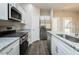 Close up of the kitchen featuring granite countertops and stainless steel appliances at 127 Tupelo Dr, Spring Hope, NC 27882