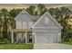 Two-story house with gray siding, a two-car garage, and a front porch at 236 White Azalea Way, Homesite 76, Benson, NC 27504