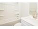 Bright bathroom featuring a shower-tub combo, white tile surround, and neutral-toned walls at 286 Yellowwood Ave, Spring Hope, NC 27882