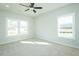 Bedroom with neutral carpet, a ceiling fan, and windows overlooking the backyard at 286 Yellowwood Ave, Spring Hope, NC 27882