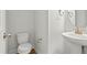 Modern half bathroom featuring a pedestal sink, updated fixtures, and clean, neutral decor at 441 Edison Rail Ln, Knightdale, NC 27545