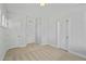 Neutral bedroom showcasing three white doors and plush carpeting at 441 Edison Rail Ln, Knightdale, NC 27545