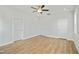 Bright bedroom featuring hardwood floors and three white doors at 441 Edison Rail Ln, Knightdale, NC 27545