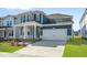 Stylish blue home with a two-car garage, covered entry, and well-maintained front lawn at 441 Edison Rail Ln, Knightdale, NC 27545