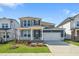Charming two-story home featuring blue siding, a two-car garage, and manicured landscaping at 441 Edison Rail Ln, Knightdale, NC 27545