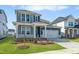 Beautiful two-story home boasts blue siding, a covered front porch, and an attached two-car garage at 441 Edison Rail Ln, Knightdale, NC 27545