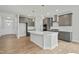 Modern kitchen featuring a large island with a white countertop and stainless steel appliances and gray cabinets at 441 Edison Rail Ln, Knightdale, NC 27545