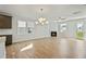 Spacious living room featuring hardwood floors, a fireplace and a large window with natural light at 441 Edison Rail Ln, Knightdale, NC 27545