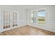 Bright office with hardwood floors, stylish French doors, and large windows overlooking the neighborhood at 441 Edison Rail Ln, Knightdale, NC 27545