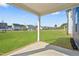 Covered patio offers a serene view of the expansive green backyard and surrounding community at 441 Edison Rail Ln, Knightdale, NC 27545