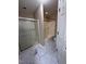 Updated bathroom with marble-look tile flooring, shower and separate tub at 4429 Log Cabin Dr, Raleigh, NC 27616