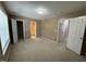 Bright, carpeted bedroom with multiple doorways and a window for natural light at 4429 Log Cabin Dr, Raleigh, NC 27616