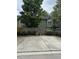 The exterior features a concrete parking pad and privacy fence with mature trees at 4429 Log Cabin Dr, Raleigh, NC 27616