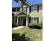 Inviting townhome featuring neutral siding, black shutters, and a well-maintained front lawn at 4429 Log Cabin Dr, Raleigh, NC 27616