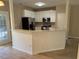 Bright and modern kitchen with white cabinets, stainless steel appliances, and a breakfast bar at 4429 Log Cabin Dr, Raleigh, NC 27616