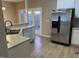 Kitchen with stainless steel appliances, double sink, and view to the outside through french doors at 4429 Log Cabin Dr, Raleigh, NC 27616