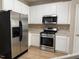 Modern kitchen featuring stainless steel appliances, ample cabinetry, and a gas range at 4429 Log Cabin Dr, Raleigh, NC 27616