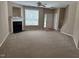 Spacious living room with plush carpeting, fireplace, and natural light from a large window at 4429 Log Cabin Dr, Raleigh, NC 27616