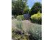 Somerset Place community signage surrounded by lush greenery and colorful flowering plants at 4429 Log Cabin Dr, Raleigh, NC 27616