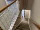 Carpeted staircase with white railing leads to a bright, inviting entrance at 4429 Log Cabin Dr, Raleigh, NC 27616