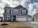 Beautiful two-story home featuring gray siding and a three-car garage at 88 Bering Cir, Angier, NC 27501