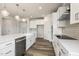 Modern kitchen with white cabinets, island with sink, and stainless steel appliances at 88 Bering Cir, Angier, NC 27501