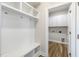 Bright mudroom features custom shelving, coat hooks, and a bench, with a laundry room adjacent at 88 Bering Cir, Angier, NC 27501