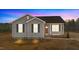 Gray exterior of charming one-story home with red door and landscaping at 145 Brookhaven Dr, Spring Hope, NC 27882