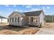 Gray exterior of charming one-story home with red door and landscaping at 145 Brookhaven Dr, Spring Hope, NC 27882