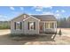 Gray exterior of charming one-story home with red door and landscaping at 145 Brookhaven Dr, Spring Hope, NC 27882