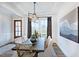 Bright dining room featuring a wood table and modern chandelier at 149 Brandy Ml, Pittsboro, NC 27312