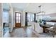 Bright dining room features hardwood floors, a large wooden table, and an elegant chandelier at 149 Brandy Ml, Pittsboro, NC 27312