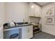Laundry room with utility sink, cabinets, and shelving at 149 Brandy Ml, Pittsboro, NC 27312