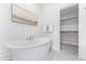 Relaxing bathroom with a freestanding tub and walk-in closet at 2417 Mayview Rd, Raleigh, NC 27607