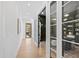Hallway leading to office with hardwood floors and decorative painting at 2417 Mayview Rd, Raleigh, NC 27607