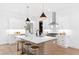 Modern kitchen featuring stainless steel appliances, a spacious island, and sleek pendant lighting at 2417 Mayview Rd, Raleigh, NC 27607
